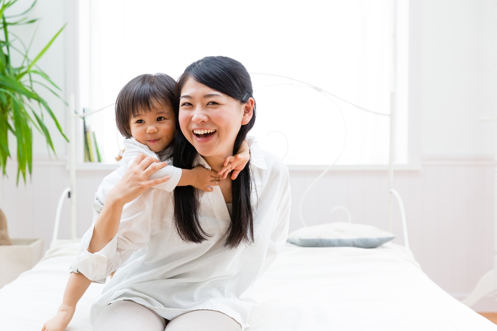 mother and child relaxing on the bed room